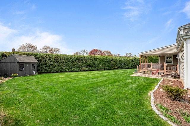 view of yard with an outdoor structure and a storage shed
