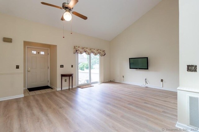 443 Lakeview Dr Unit 443, Southington, CT 06489 - unfurnished living room featuring a ceiling fan, high vaulted ceiling, light wood-type flooring, and baseboards