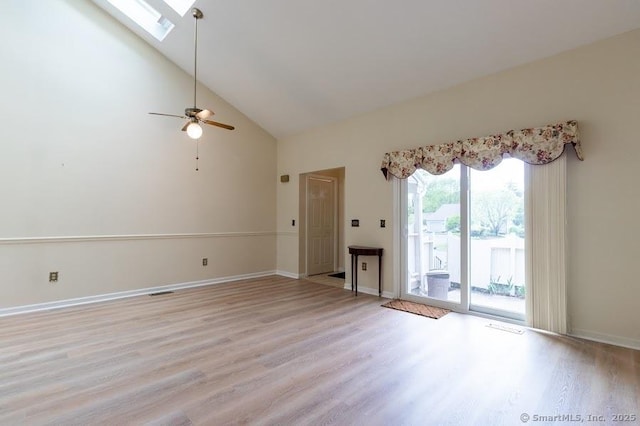 443 Lakeview Dr Unit 443, Southington, CT 06489 - unfurnished living room featuring a skylight, light wood-style flooring, high vaulted ceiling, a ceiling fan, and baseboards