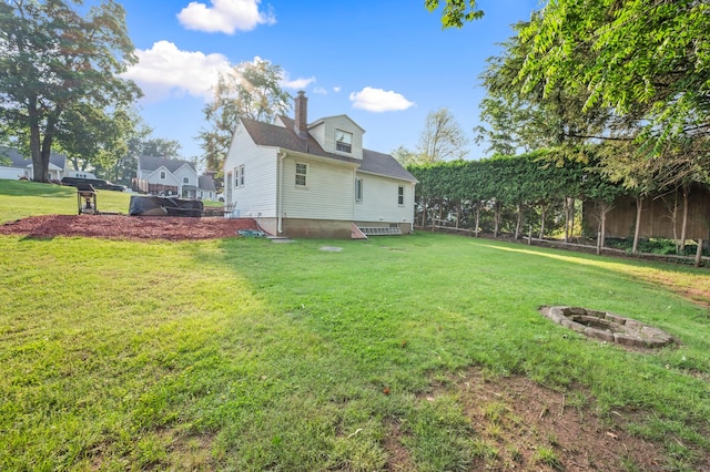 12 Homecrest St, Newington, CT 06111 - back of house featuring a fire pit, a yard, and a chimney