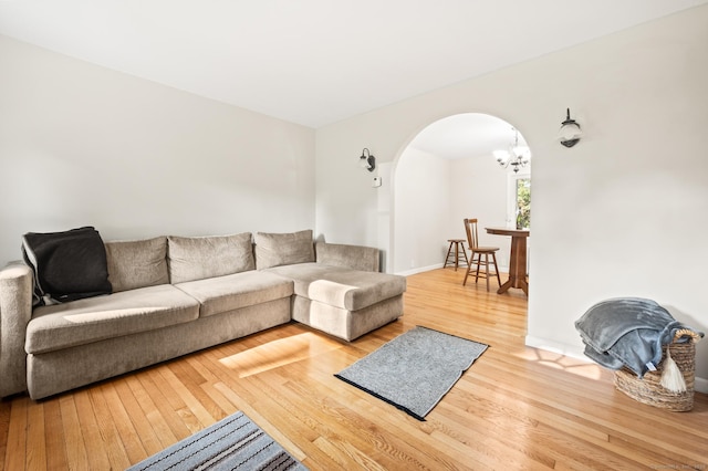 12 Homecrest St, Newington, CT 06111 - living area with arched walkways, wood finished floors, and a chandelier