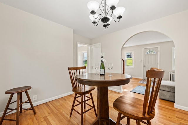 12 Homecrest St, Newington, CT 06111 - dining space with arched walkways, radiator, light wood finished floors, and a chandelier
