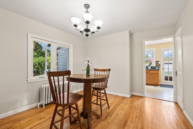 12 Homecrest St, Newington, CT 06111 - dining space with radiator heating unit, a chandelier, and light wood finished floors