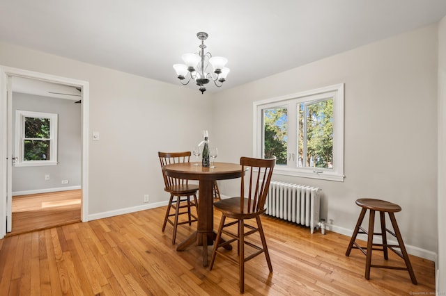 12 Homecrest St, Newington, CT 06111 - dining area with radiator, a chandelier, and light wood-type flooring