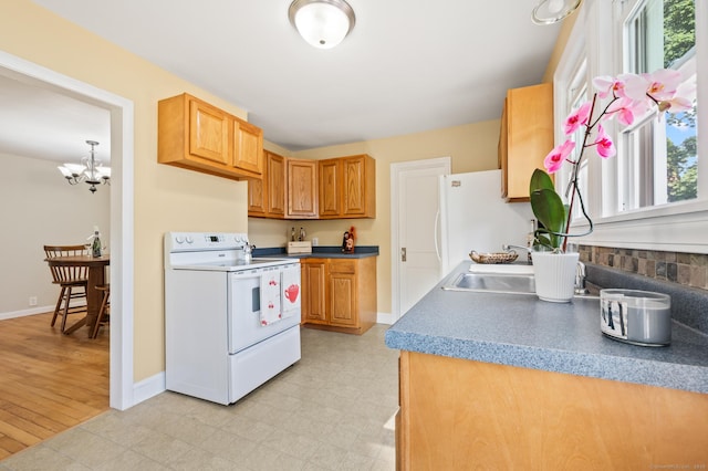 12 Homecrest St, Newington, CT 06111 - kitchen featuring white appliances, healthy amount of natural light, a chandelier, and light floors
