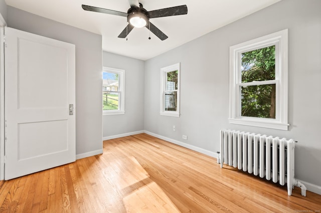 12 Homecrest St, Newington, CT 06111 - empty room featuring radiator, light wood-type flooring, and ceiling fan