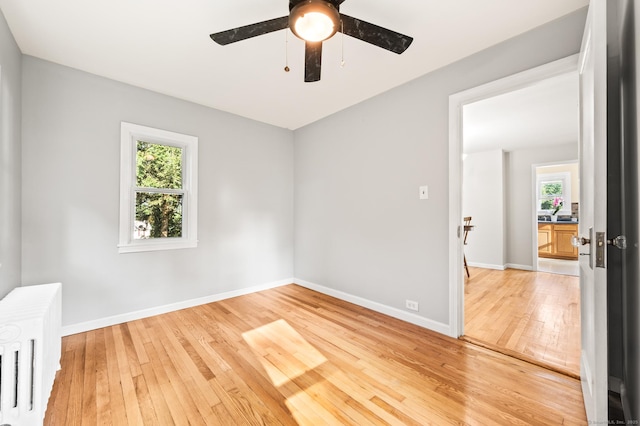 12 Homecrest St, Newington, CT 06111 - unfurnished room with radiator heating unit, light wood-style flooring, and ceiling fan