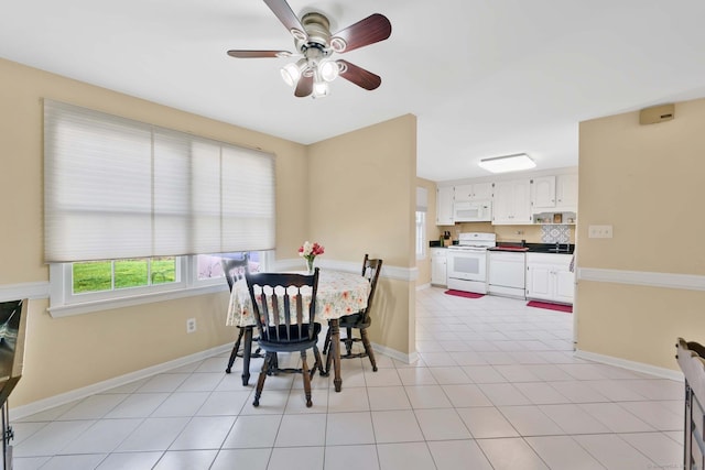 dining area with baseboards, ceiling fan, and light tile patterned floors