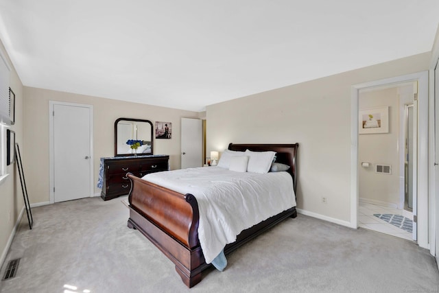 bedroom featuring baseboards, visible vents, and light carpet