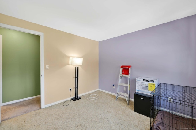 misc room featuring carpet floors and baseboards