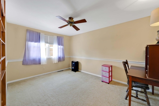 unfurnished office featuring baseboards, a ceiling fan, carpet flooring, and visible vents