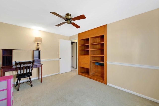 carpeted office featuring baseboards and ceiling fan