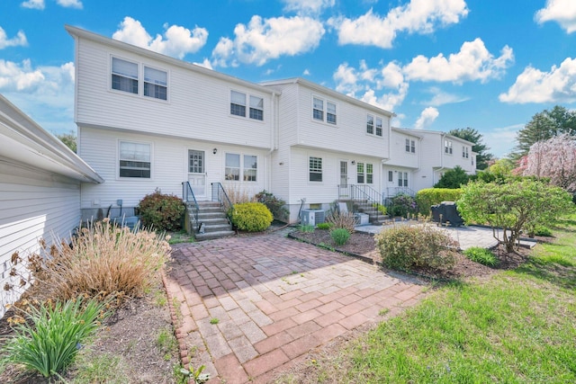 back of property featuring central air condition unit and a patio area
