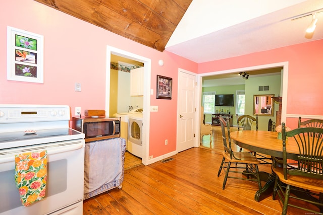 581 Oxford Rd, Oxford, CT 06478 - dining room with washing machine and clothes dryer, light wood-style flooring, and lofted ceiling
