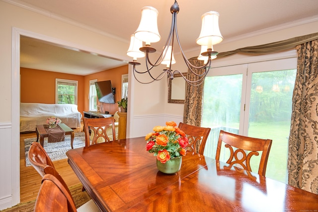 581 Oxford Rd, Oxford, CT 06478 - dining space featuring wainscoting, crown molding, wood finished floors, a chandelier, and a decorative wall