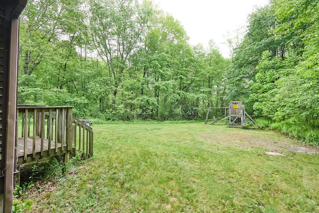 581 Oxford Rd, Oxford, CT 06478 - view of grassy yard with a wooden deck, a playground, and a view of trees