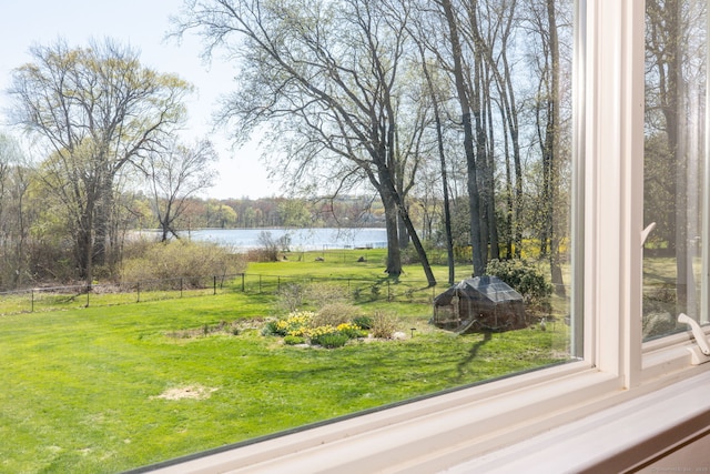 view of yard featuring fence and a water view