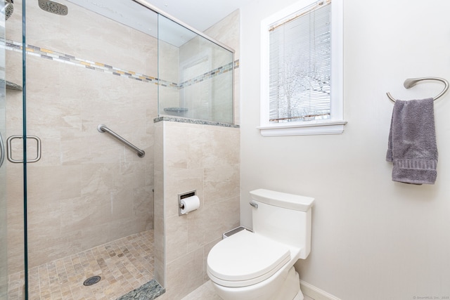 bathroom with toilet and a shower stall