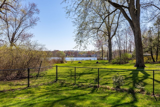 view of yard featuring a water view and fence