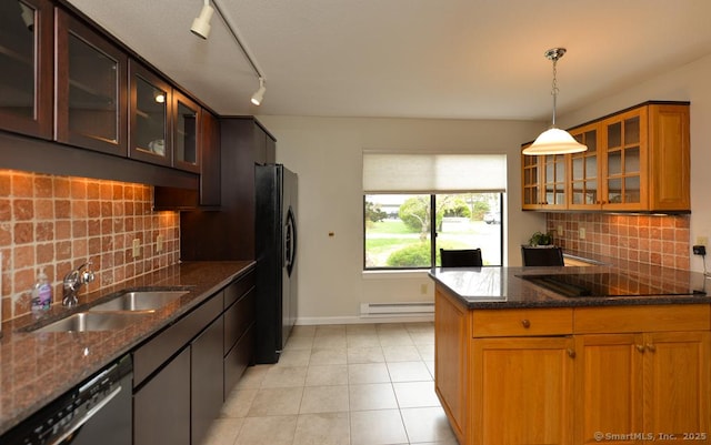 kitchen with a sink, a baseboard heating unit, dark stone counters, black appliances, and glass insert cabinets