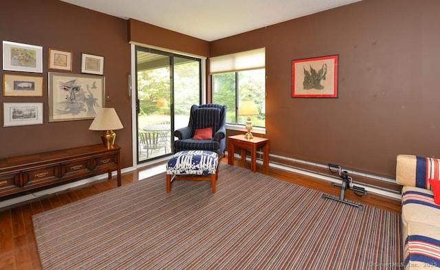 living area featuring baseboards and wood finished floors