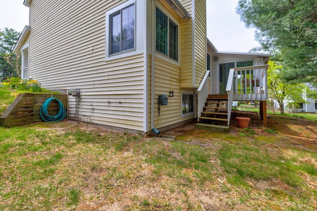 view of home's exterior with a wooden deck and stairway
