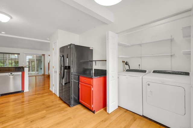 laundry area featuring laundry area, light wood finished floors, and washing machine and clothes dryer
