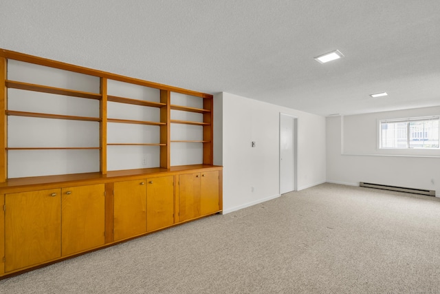 empty room with baseboards, a textured ceiling, light carpet, and baseboard heating