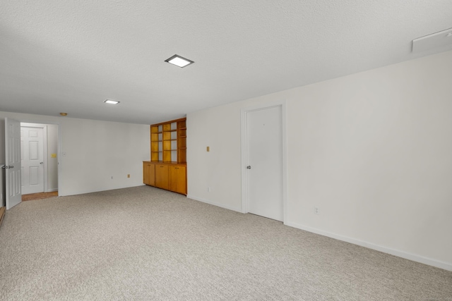 12 Southbridge Ct Unit 12, Simsbury, CT 06070 - empty room featuring light colored carpet, baseboards, and a textured ceiling