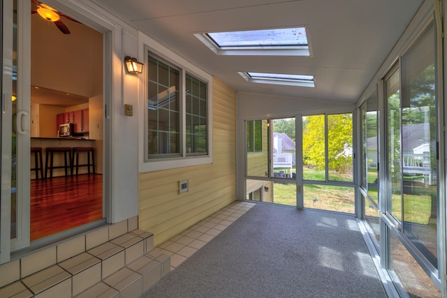 unfurnished sunroom featuring a skylight