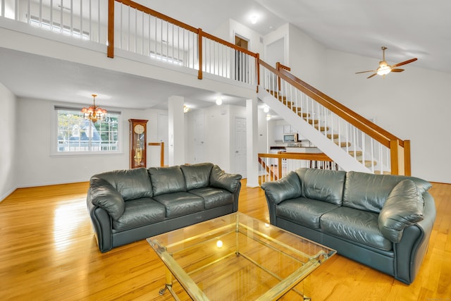 12 Southbridge Ct Unit 12, Simsbury, CT 06070 - living room featuring high vaulted ceiling, stairs, light wood-type flooring, a ceiling fan, and a chandelier