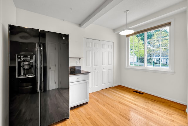 12 Southbridge Ct Unit 12, Simsbury, CT 06070 - kitchen featuring black fridge, light wood-style floors, beam ceiling, dark countertops, and baseboards