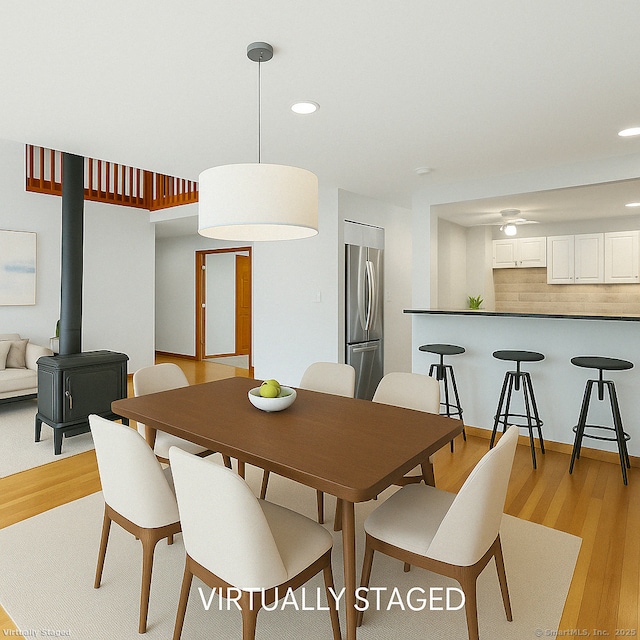210 Founders Way, Stratford, CT 06614 - dining space featuring recessed lighting, light wood-type flooring, and a wood stove