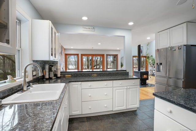 210 Founders Way, Stratford, CT 06614 - kitchen with stainless steel fridge, white cabinetry, and a sink