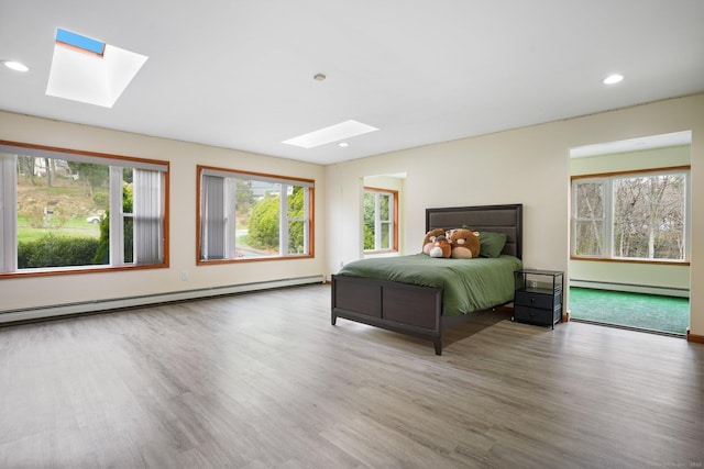 210 Founders Way, Stratford, CT 06614 - bedroom with a skylight, baseboard heating, wood finished floors, and recessed lighting
