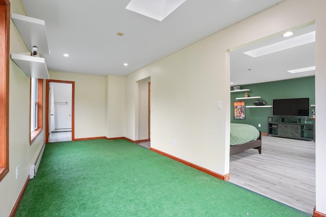 210 Founders Way, Stratford, CT 06614 - carpeted spare room featuring a skylight, baseboards, and a baseboard heating unit