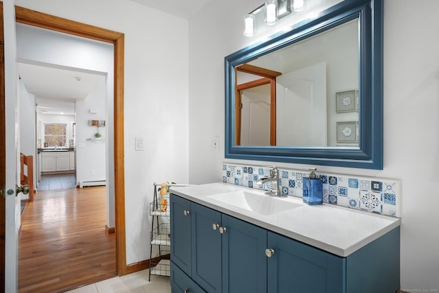 210 Founders Way, Stratford, CT 06614 - bathroom with tasteful backsplash, baseboards, wood finished floors, vanity, and a baseboard radiator