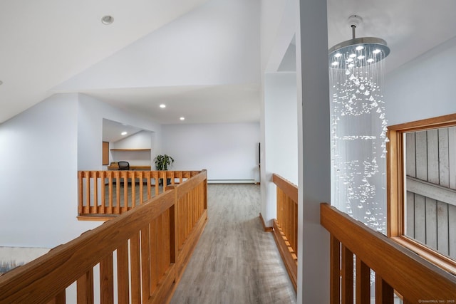 210 Founders Way, Stratford, CT 06614 - hallway with an inviting chandelier, vaulted ceiling, an upstairs landing, light wood-style floors, and baseboard heating