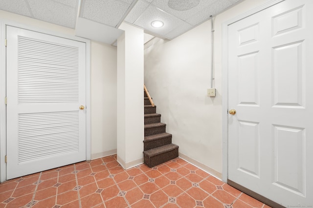 interior space featuring baseboards, recessed lighting, and a drop ceiling