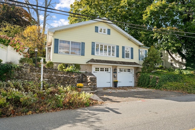 view of front of house with an attached garage and aphalt driveway
