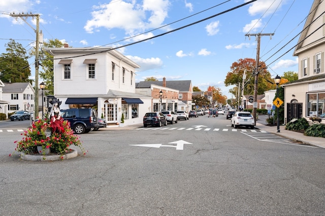 view of street with sidewalks, curbs, street lighting, and a residential view