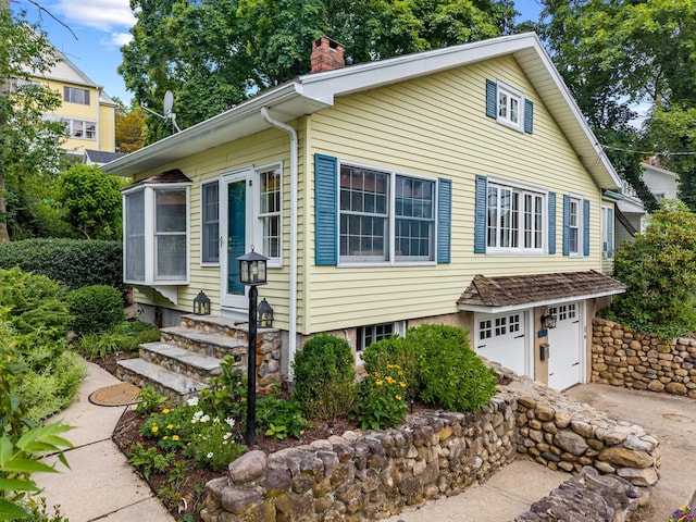 16 N Main St, Essex, CT 06426 - view of front of home featuring a chimney, driveway, entry steps, and a garage