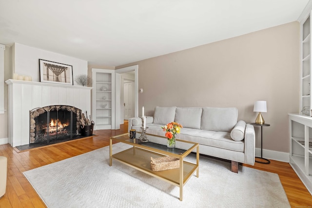 16 N Main St, Essex, CT 06426 - living area with a lit fireplace and wood finished floors