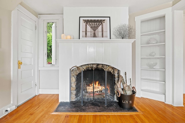 16 N Main St, Essex, CT 06426 - detailed view of wood finished floors, a brick fireplace, and built in features