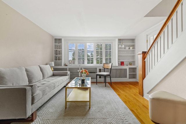 16 N Main St, Essex, CT 06426 - living room featuring wood finished floors, built in features, stairs, and radiator heating unit