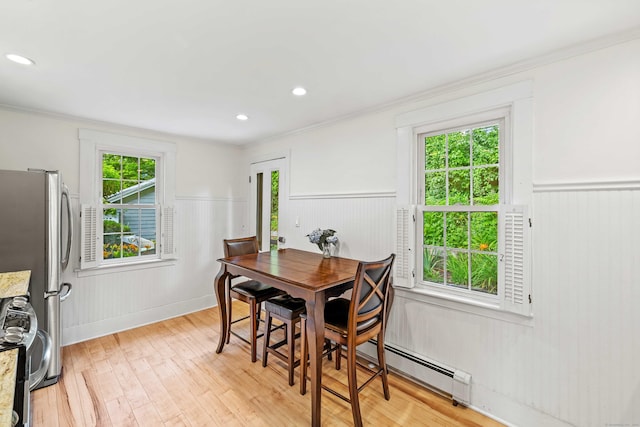16 N Main St, Essex, CT 06426 - dining area featuring wainscoting, light wood-style flooring, a baseboard radiator, crown molding, and recessed lighting