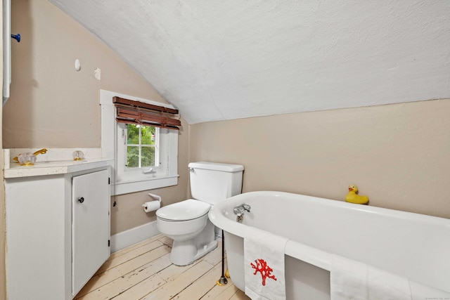 16 N Main St, Essex, CT 06426 - full bath featuring lofted ceiling, a soaking tub, vanity, a textured ceiling, and wood finished floors