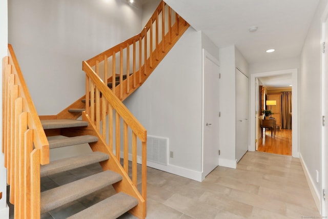 stairs with baseboards, recessed lighting, and visible vents