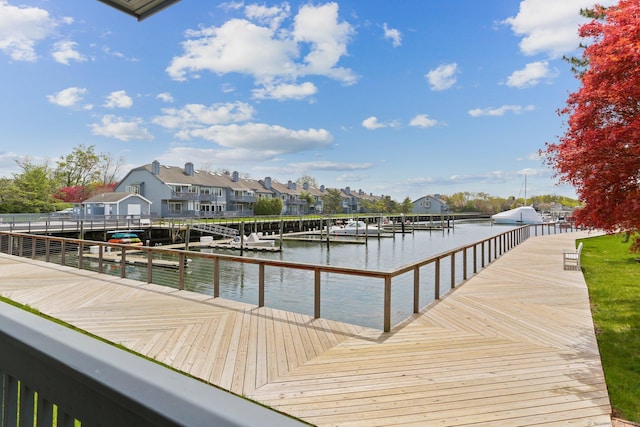 dock area featuring a water view and a residential view