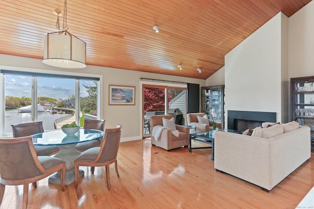 interior space featuring a healthy amount of sunlight, wooden ceiling, light wood-style flooring, and lofted ceiling